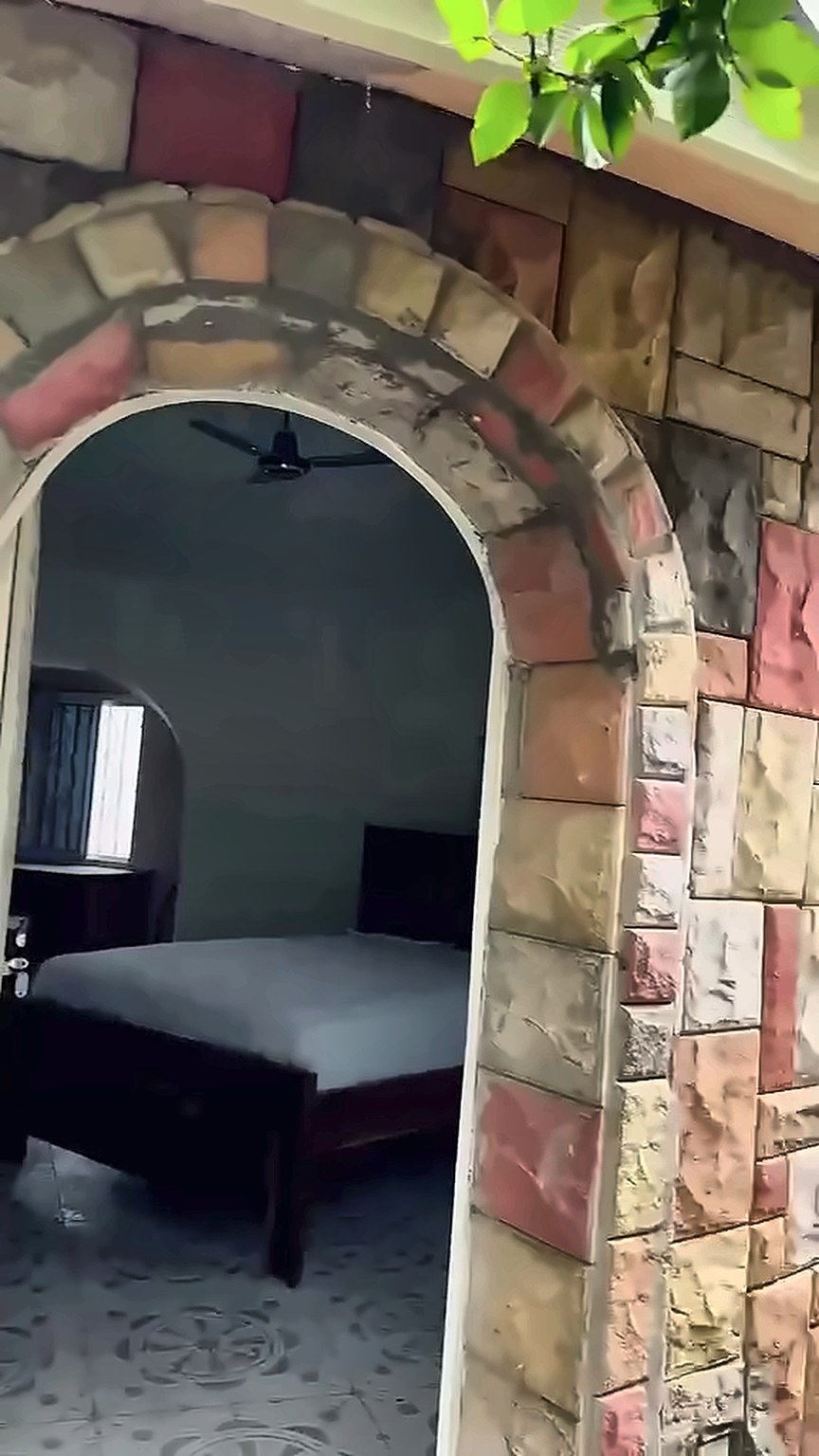 View through the stone arch into the bedroom
