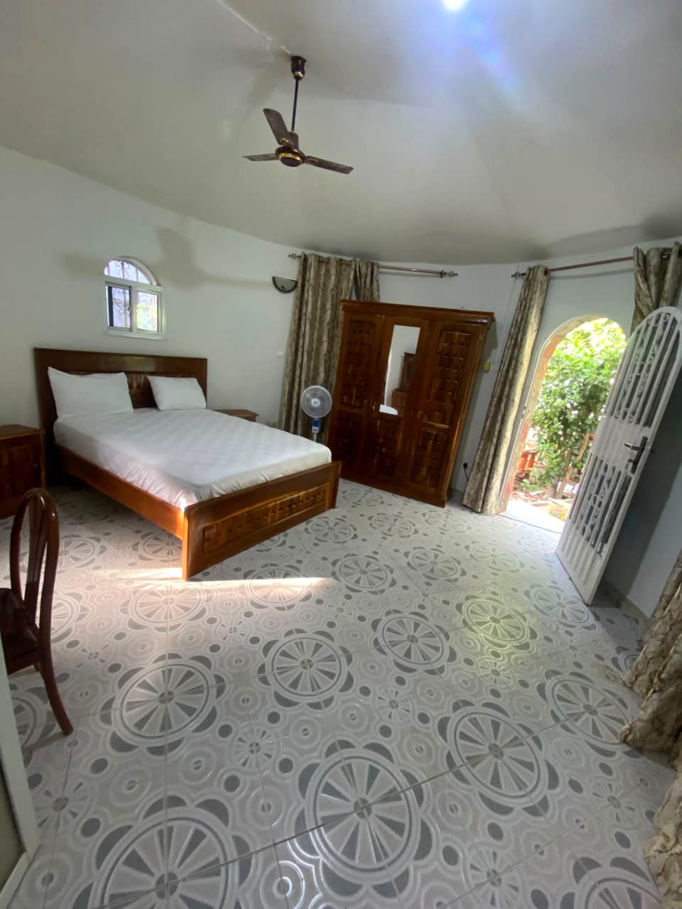 Bedroom with ceiling fan and door to the garden