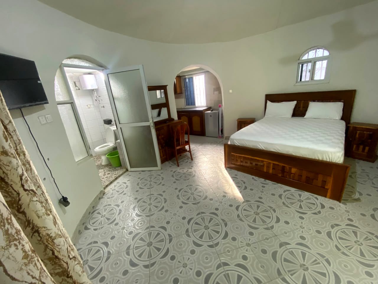 Inside the Round House: bed, kitchenette and bathroom behind arched doorways