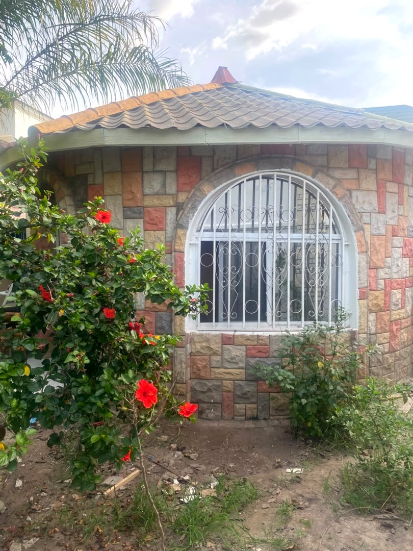 Arched window of the Round House with hibiscus